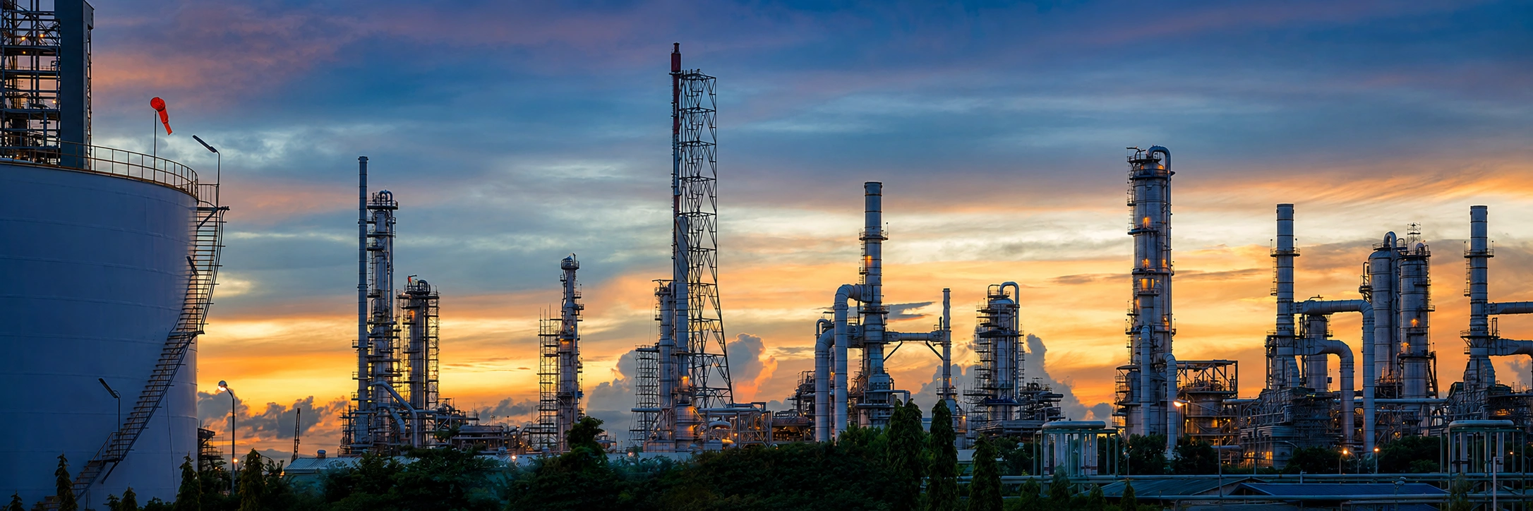 Oil and gas processing infrastructure with pipelines, towers, and pressure equipment
